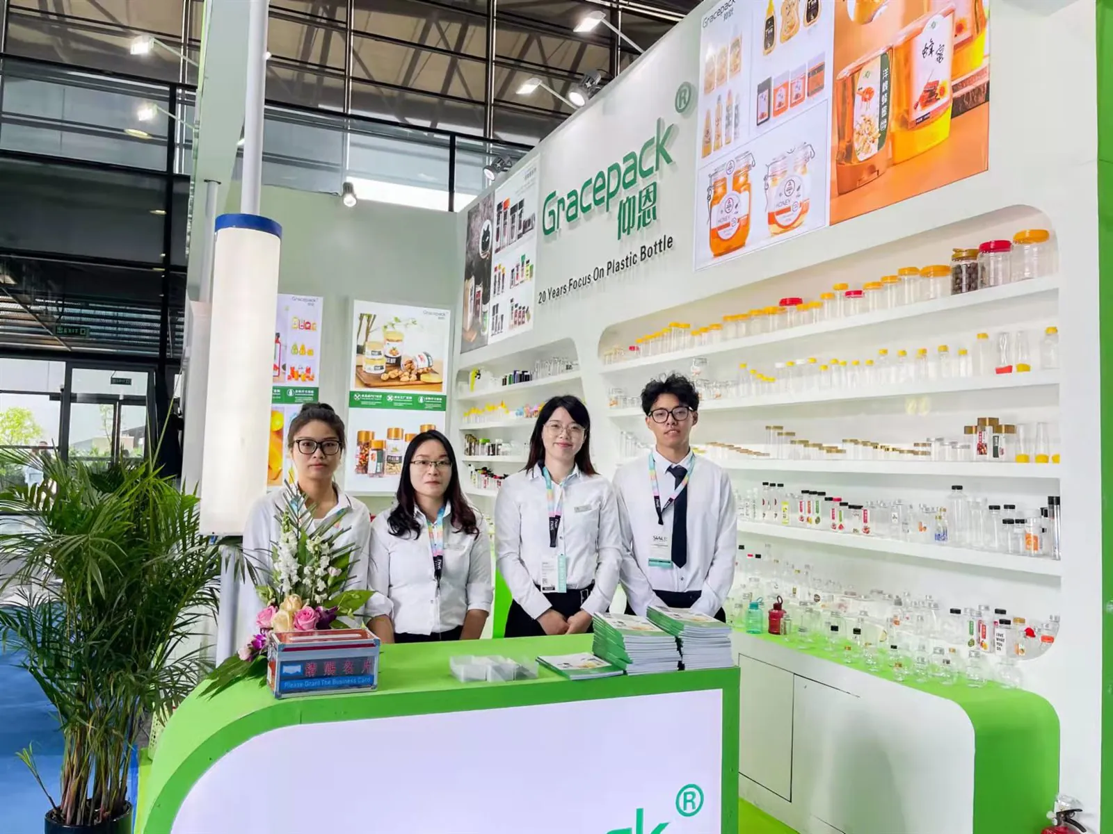 Gracepack team at the 2021 China Food Exhibition booth with food-grade plastic bottles and jars