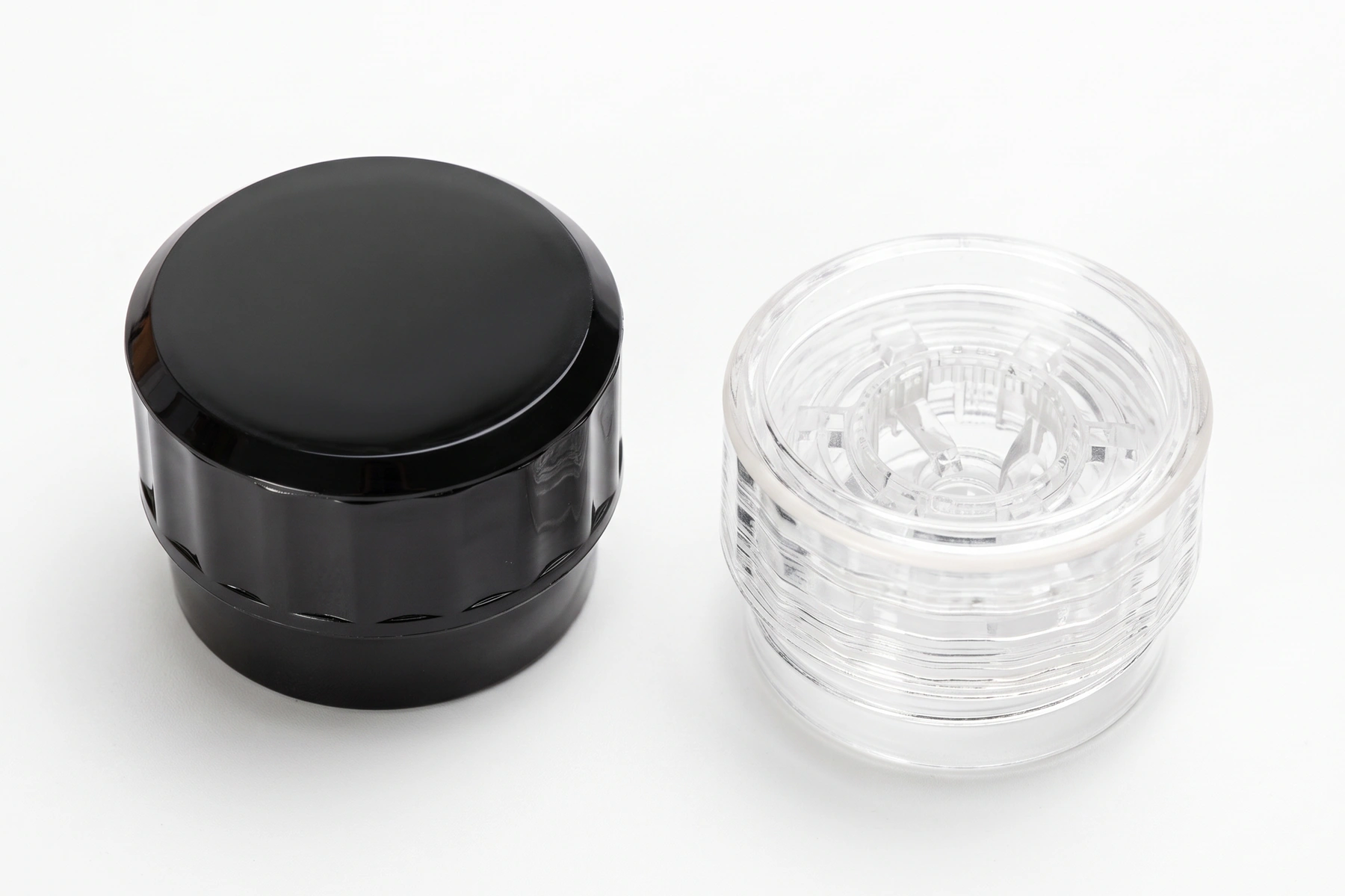 Black and clear grinder caps for spice jars shown side by side